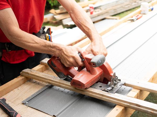 Circular saw cutting timber on a construction site (illustrative stock photo)