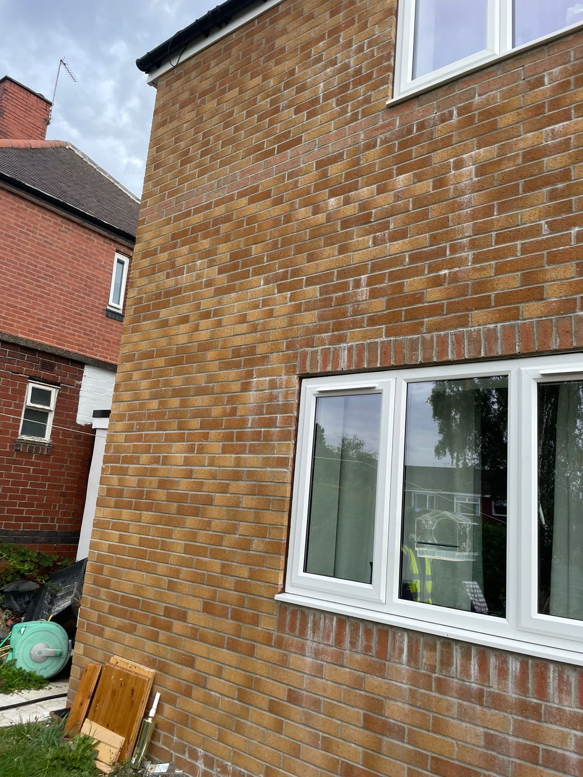 Completed new-build brick elevation with white uPVC windows