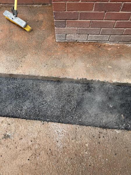 Reinstated strip beside brickwork