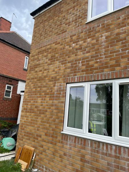 Completed new-build brick elevation with white uPVC windows