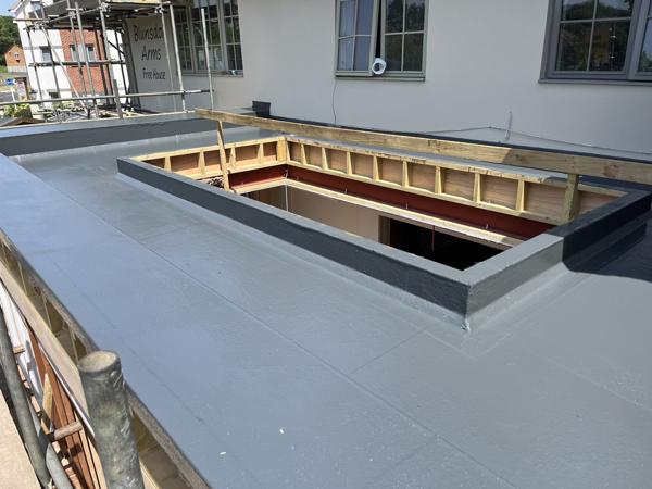 GRP fibreglass flat roof with roof lanterns on an extension